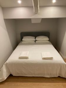 a large white bed with two white towels on it at Douro Villa 3 - Best View in Town in Vila Nova de Gaia