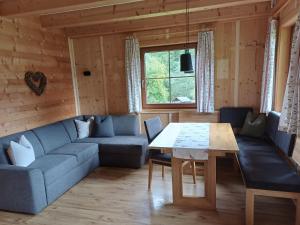 a living room with a couch and a table at Ferienwohnung Hinterwinkl in Achenkirch +39 photos