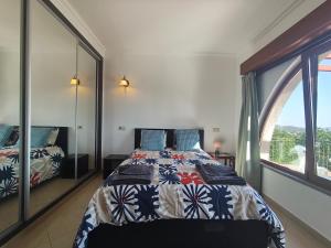a bedroom with a bed and a large window at Casa do Miradouro in São Brás de Alportel +17 photos