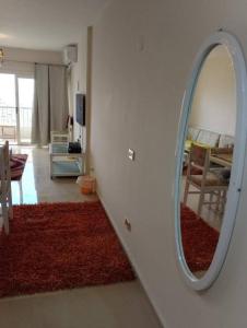 a living room with a mirror on the wall at شقه على البحر مباشره فى عمارات الظباط مصطفى كامل سيتي اسكوير in Alexandria