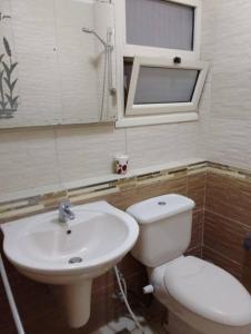 a bathroom with a toilet and a sink at شقه على البحر مباشره فى عمارات الظباط مصطفى كامل سيتي اسكوير in Alexandria +13 photos