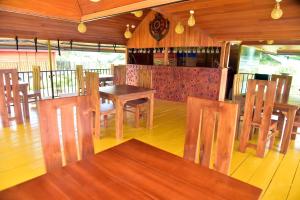 a dining room with wooden tables and chairs at Villa I Did in Beruwala