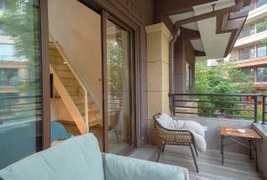 a balcony with a couch and a stair case at Heinemanns Guest House With Jacuzzi Local Family vibes in Baoguosi