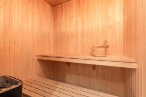 a sauna with a wooden shelf with a container on it at Åre Travel - Åre Parken 18 in Åre +18 photos