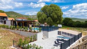 a house with a swimming pool and a fence at KAPO Mobile Home in Sitno Donje