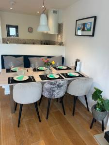 a dining room table with chairs and a dining room at Escape to Infinity! in Guernsey