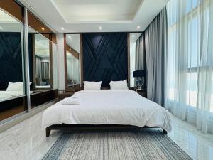 a bedroom with a large bed and a large window at Breathtaking Sea Views& Balcony Luxurious Stay in Manama +10 photos