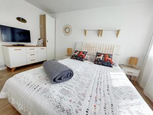 a bedroom with a bed with a white comforter at Sielankowo in Wisła