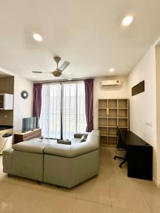 a living room with a couch and a desk at D'pristine 4 bedroom condo 1725 opposite Legoland and Medini mall in Iskandar Puteri