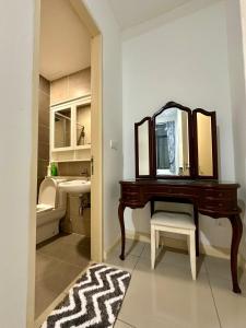 a bathroom with a vanity with a mirror and a sink at D'pristine 4 bedroom condo 1725 opposite Legoland and Medini mall in Iskandar Puteri
