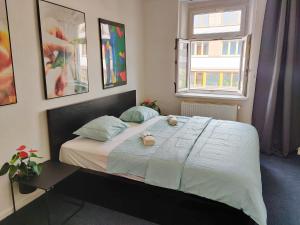 a bedroom with a bed with two stuffed animals on it at Local Vibe - Zizkov Private Room in Prague