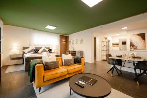 a living room with a couch and a table at Spa Cottage Serenity Chalet in Rittersdorf