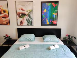 a bedroom with a bed with two slippers on it at Local Vibe - Zizkov Private Room in Prague +1 photo