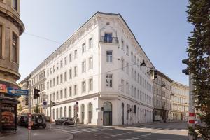 a white building on the corner of a street at Fesh Lofts in Vienna