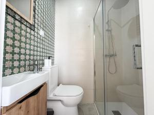 a bathroom with a toilet sink and a shower at VT Guest House in Setúbal +37 photos