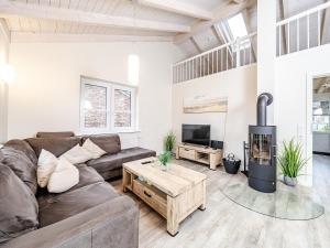 a living room with a couch and a fireplace at Moderne Doppelhaushälfte - perfekt zu zweit in Dagebüll +21 photos