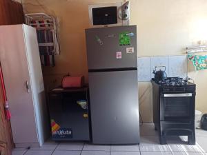 a kitchen with a refrigerator and a stove and a microwave at apta para cargar auto eléctrico casa verde 2 pisos in Rivera +15 photos