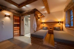 a bathroom with two beds in a room with a shower at Ferienwohnungen Fendl in Fischbachau