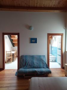 a bedroom with a bed and a dining room at Agriturismo Coi de Pera in Ponte nellʼAlpi