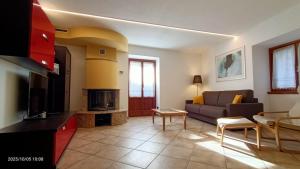 a living room with a couch and a tv at Residenza dentro le mura - 5 min walk to Bernina Express in Tirano
