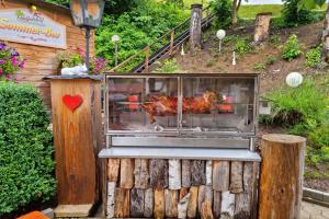 a turkey cooking in a grill in a garden at pfefferHÄUSL in Regen +25 photos