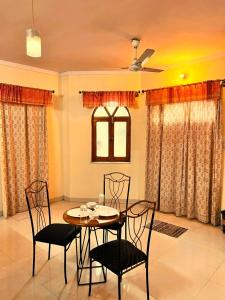 a dining room with a table and two chairs at Hotel Classic Inn in Jāmb