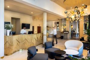 a lobby with chairs and a reception desk at Rezydent Hotel Sopot - MGallery Collection in Sopot