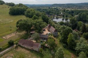 an aerial view of a house and a river at Domaine De Vic in Le Buisson