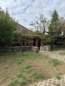 a house with a red door and some plants at Dreamy Cottage in Ayiá