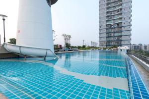 a swimming pool on the roof of a building at Supalai Mare Pattaya & City Center in Pattaya South