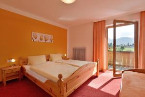 a bedroom with a bed and a large window at Gästehaus Wurm in Stumm +25 photos