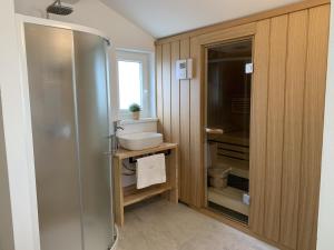a bathroom with a shower and a sink at Villa Allegra Istriana in Fazana with sea view & spa in Fažana