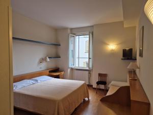 a hotel room with a bed and a window at Hotel Tre Re in Como