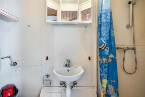 a bathroom with a sink and a shower at Bungalow 21 - Kimbucht in Reichendorf +17 photos