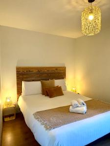 a bedroom with a bed with two towels on it at Les Pierres Dorées, demeure de caractère in Montels