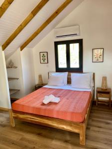a bedroom with a large bed in a attic at Caribbean Shelter in Bouillante +21 photos