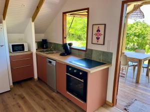 a kitchen with a sink and a stove top oven at Caribbean Shelter in Bouillante