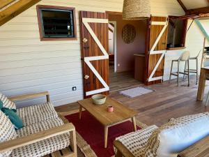 a living room with a couch and a table at Caribbean Shelter in Bouillante