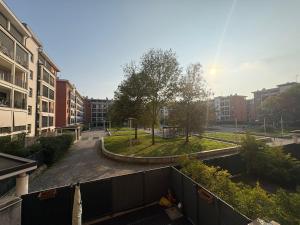 a view of a courtyard in a city with buildings at la iaia's home in Rozzano