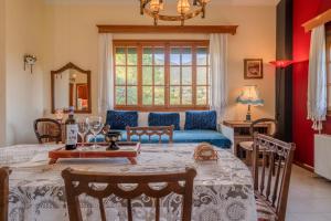 a living room with a table and a couch at Selini Suite 2nd floor Panoramic Vineyard Views in Kallithea