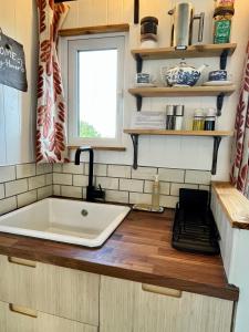 a kitchen with a tub and a sink at Tŷ Ni Tiny Houses in Bridell +70 photos
