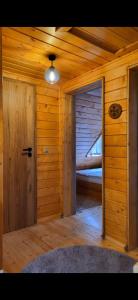 an empty room with a door in a log cabin at Cabana La Iura in Bistra +5 photos