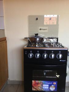 Η κουζίνα ή μικρή κουζίνα στο NOOMA PRESTIGE OUAGa 2000