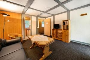a living room with a couch and a table at Bungalow 30 - Kimbucht in Reichendorf