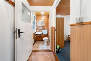 a bathroom with a toilet and a sink at Bungalow 32 - Kimbucht in Reichendorf +16 photos