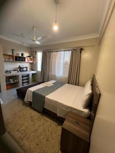 a bedroom with a large bed in a room at holm's home studio in Diani Beach