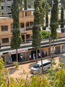 a white car parked in front of a building at holm's home studio in Diani Beach