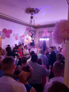 a crowd of people standing in a room with balloons at Palac Kursko Agroturystik in Kursko