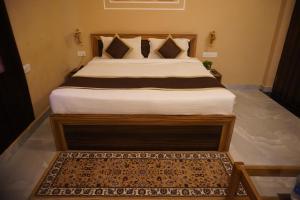 a bedroom with a large bed with a rug at Bagh mahal by jungle vibes in Sawāi Mādhopur +5 photos