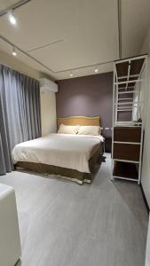 a bedroom with a large bed and a book shelf at C House 角屋 in Hsinchu City